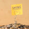 Pile of coins with saving label on a wooden table. Financial Concept.