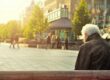 man sitting on brown wooden bench